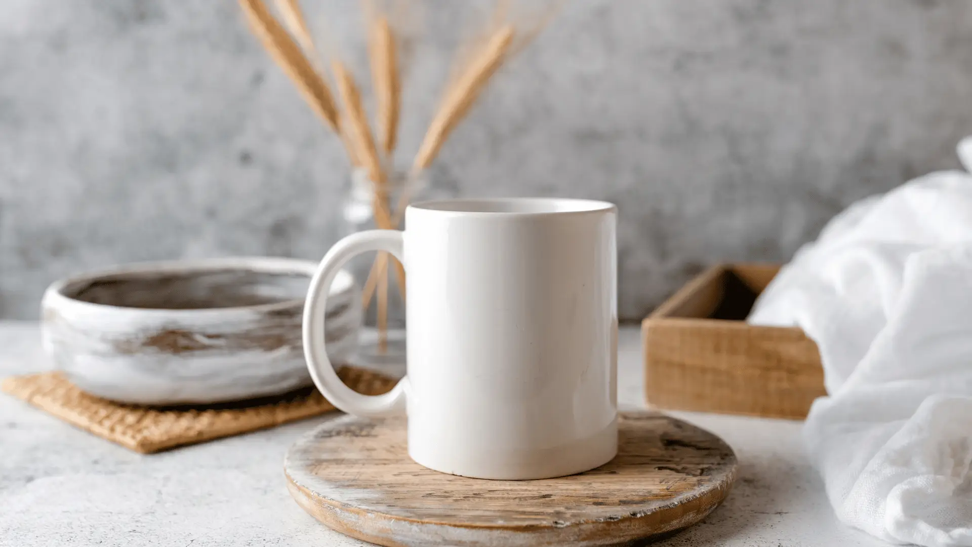 White ceramic coffee mug placed on a wooden base with a textured background.