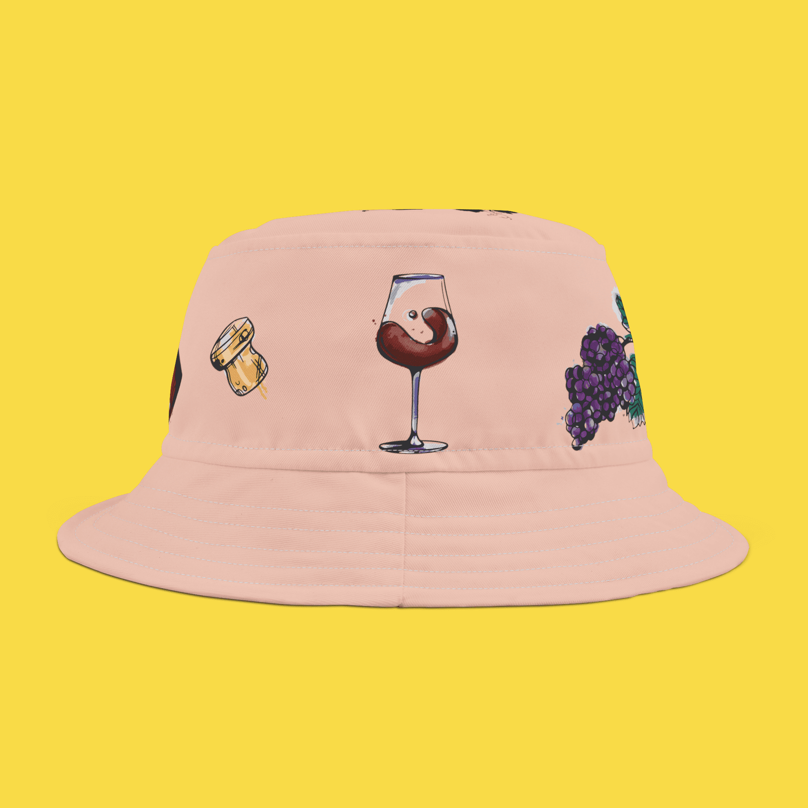 Peach colored bucket hat with illustration of wine grapes and wine glass