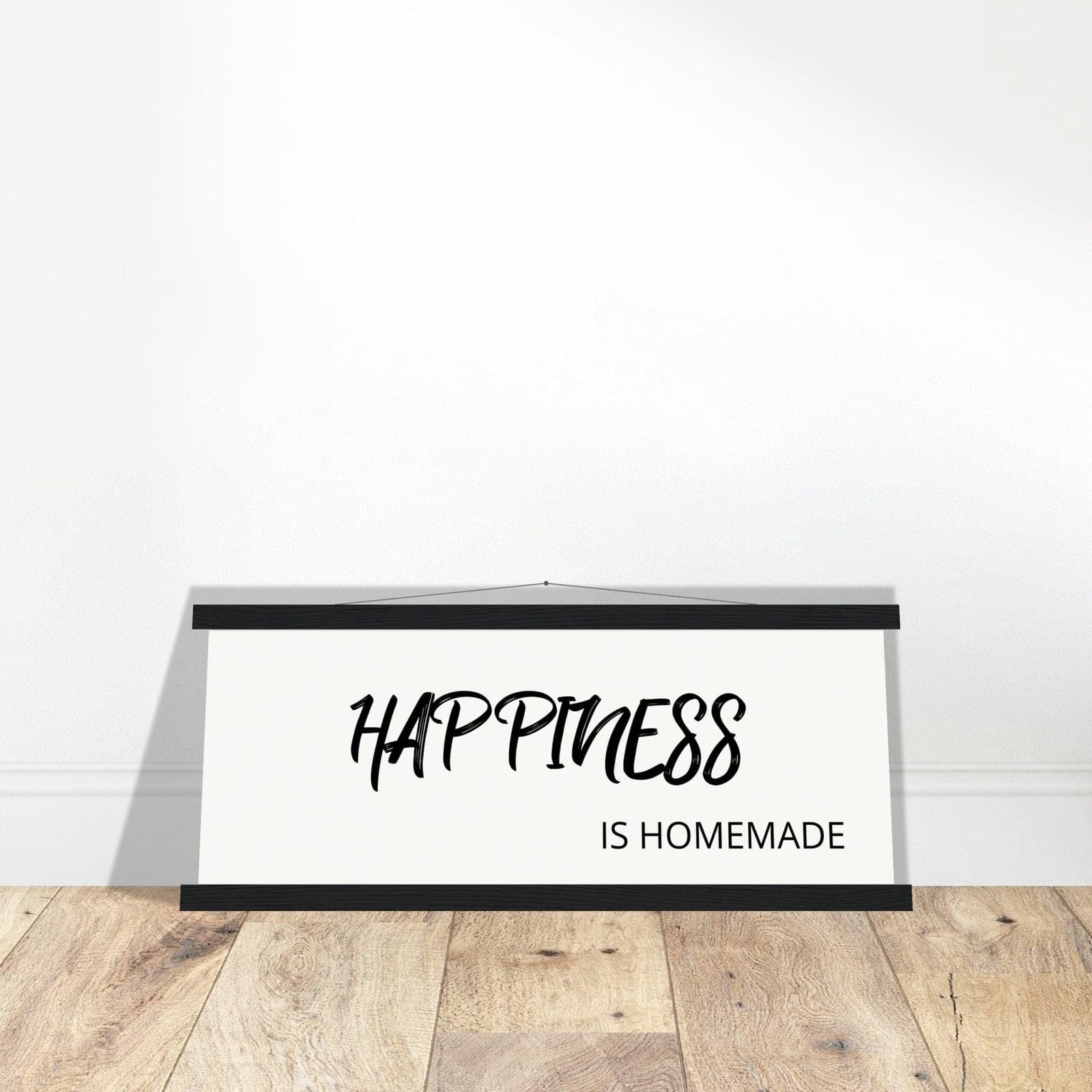 Framed wall art displaying the quote 'Happiness is Homemade' in black cursive text on a white background.